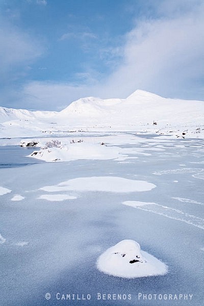 Meall A'Bhuiridh across a frozen Lochan na Stainge during the twilight hjours before sunrise