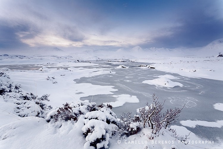 A frozen Lochan na Stainge on Rannoch Moor. The Black Mount hills and Meall a' Bhùiridh can be seen in the distance.