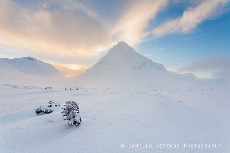 Knee to chest-deep snow covering the bogs in front of the Buachaille Etive Beag at sunset.