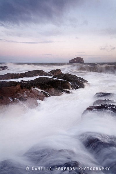 Retreating waves blurred by using a long exposure, Seacliff beach at dawn.