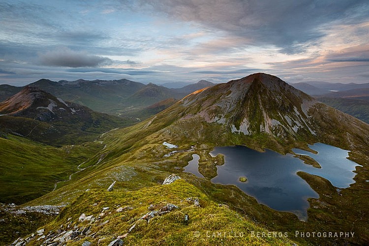 Binnein Beag (left) and Sgurr Eilde Mor as the setting sun pierces through the clouds.