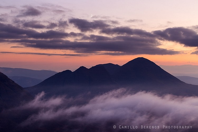 Waxing crescent moon above Beinn Alligin at dusk.