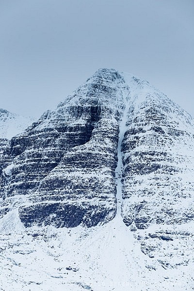 Morrison's gully leading up the steep snowy slopes of Sail Mhor in winter